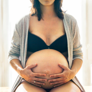 Pregnant woman touching belly