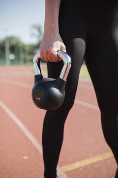 Fitness woman holding 8 kg weight