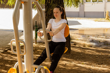 Young girl doing exerciese outdoor on sunny day