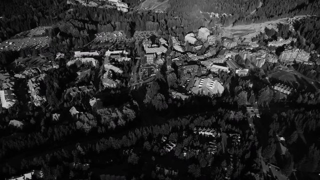 Black and White Aerial Over Whistler Village Panning to Blackcomb Mountain