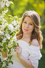 Naklejka premium A pregnant woman walks in the flowered gardens 8233.
