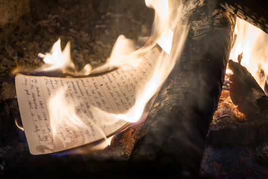 Burning journal or book in campfire