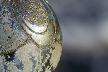 Close Look at a Frozen Golden Outdoor Christmas Ornament