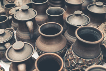 Many handmade brown clay pots, bowls, mugs