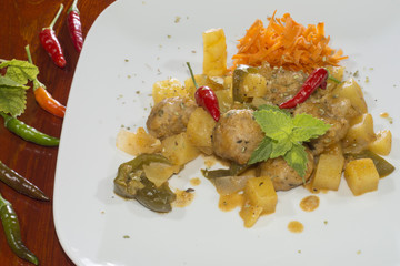homemade  meatballs with  vegetables, 
seasoned with dried oregano leaves
