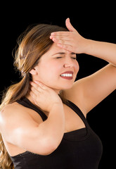 Close up of a beautiful young lady Suffer crick after workout with a hand in her forehead, in a black background