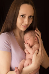 newborn baby mom hands on