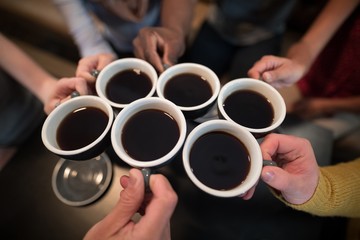 Obraz na płótnie Canvas Mid section of friends toasting coffee