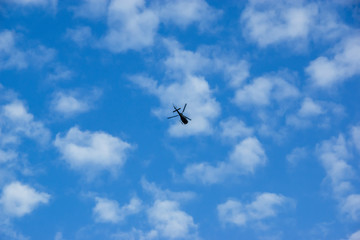 Fototapeta na wymiar Helicopter flies in the sky