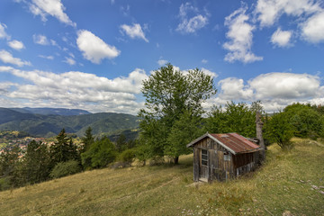 Fototapeta na wymiar beauty daily landscape of alone old wooden house on a hill in a mountain