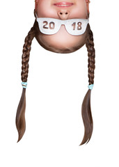 Funny girl with pigtails wearing glasses with an inscription 2018 upside down. Head portrait...