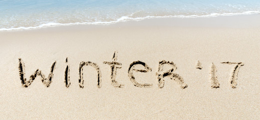 Winter 2017 sign sand near sea ocean tropic beach