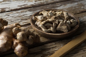 High angle view of dried gingers in plate on weathered table