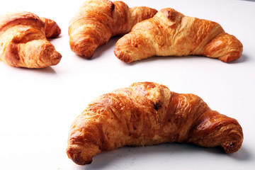 freshly baked croissants on white board, bakery concept