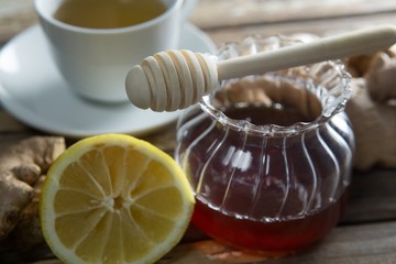 Close up of fresh honey and lemon with ginger tea