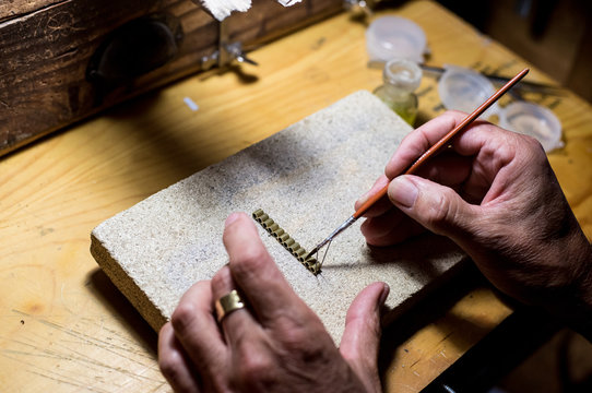 Jeweler making a necklace on his wokshop