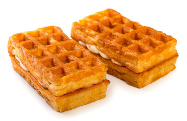 Pair of fresh soft belgian waffles isolated on white background, close up.