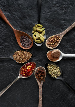 Dried exotic spices on different beautiful spoons