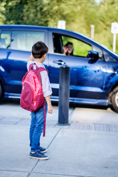 Back To School: Asian Mother Dropping Off Her Kid At School