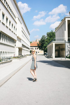 Blonde woman in a dress walking