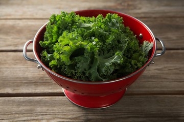 Close-up of kale in colander on table