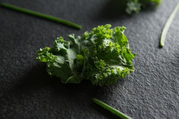 Obraz na płótnie Canvas Close up of fresh kale on slate
