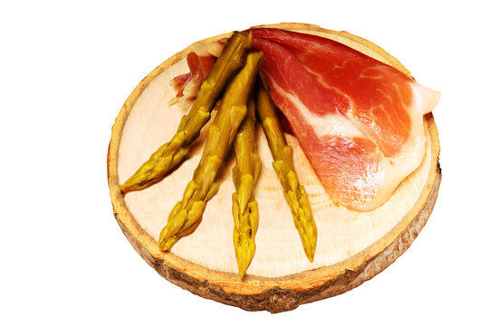 starters of ham and asparagus in wooden dish , isolated on white background