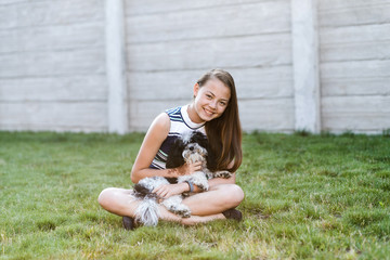 Smiling Teen Holding Her Puppy