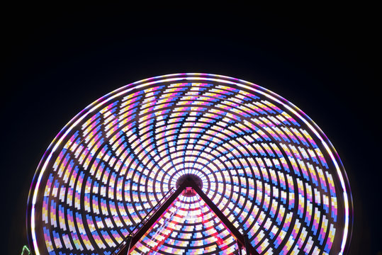 Spinning ferris wheel at night, abstract