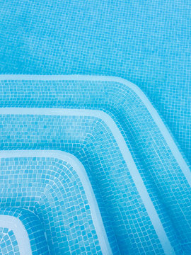 Blue and white mosaic tiled pool steps