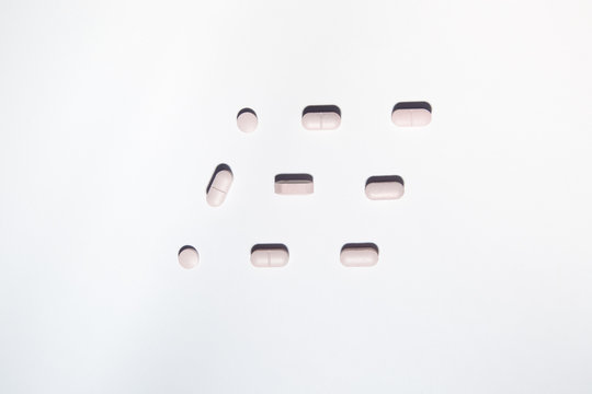 Pink pills shaping a rhombus
