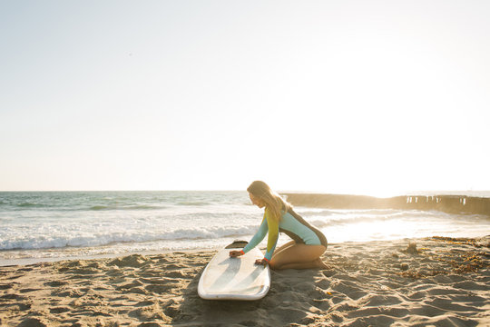 Pretty Girl Surfing On The Beach In Summer