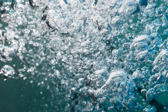 Air bubbles exhaled by a scuba diver expending on their way towards the surface