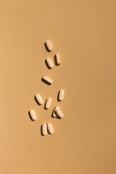 orange pills scattered across orange surface