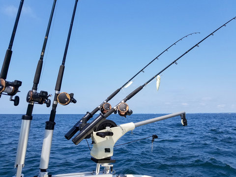 fishing rods and reels with lure on boat on Lake Michigan