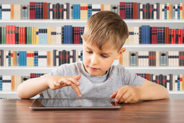 Boy Using Digital Tablet At School