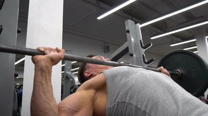 Man lifting the barbell in the gym