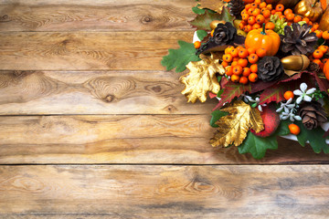Fall greeting with berries and cones wreath, copy space