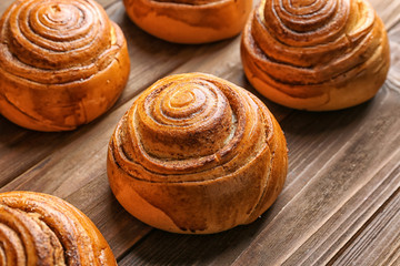 Sweet cinnamon rolls on wooden table