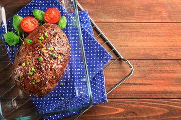 Tasty baked turkey meatloaf on wooden table