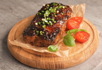 Tasty baked turkey meatloaf on wooden board