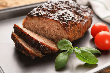 Tasty turkey meatloaf on baking tray, closeup