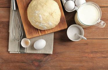 Raw dough and ingredients on kitchen table. Cooking classes concept