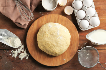 Raw dough and ingredients on kitchen table. Cooking classes concept