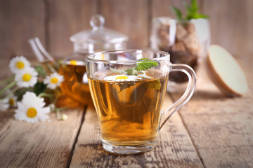 Cup of chamomile tea on wooden background