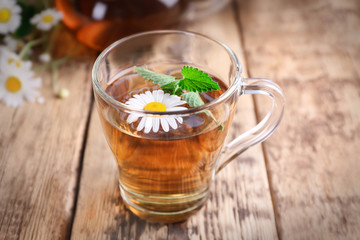 Cup of chamomile tea on wooden background