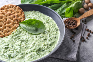 Frying pan with spinach dip and cookies on table