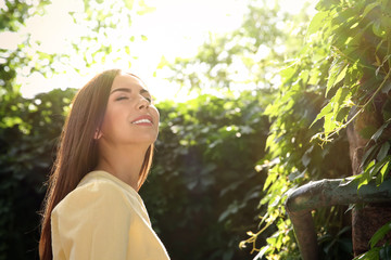Fototapeta premium Beautiful young woman outdoors on sunny day