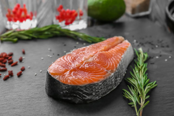 Fresh salmon steak with rosemary on slate plate