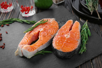 Fresh salmon steaks with rosemary on slate plate